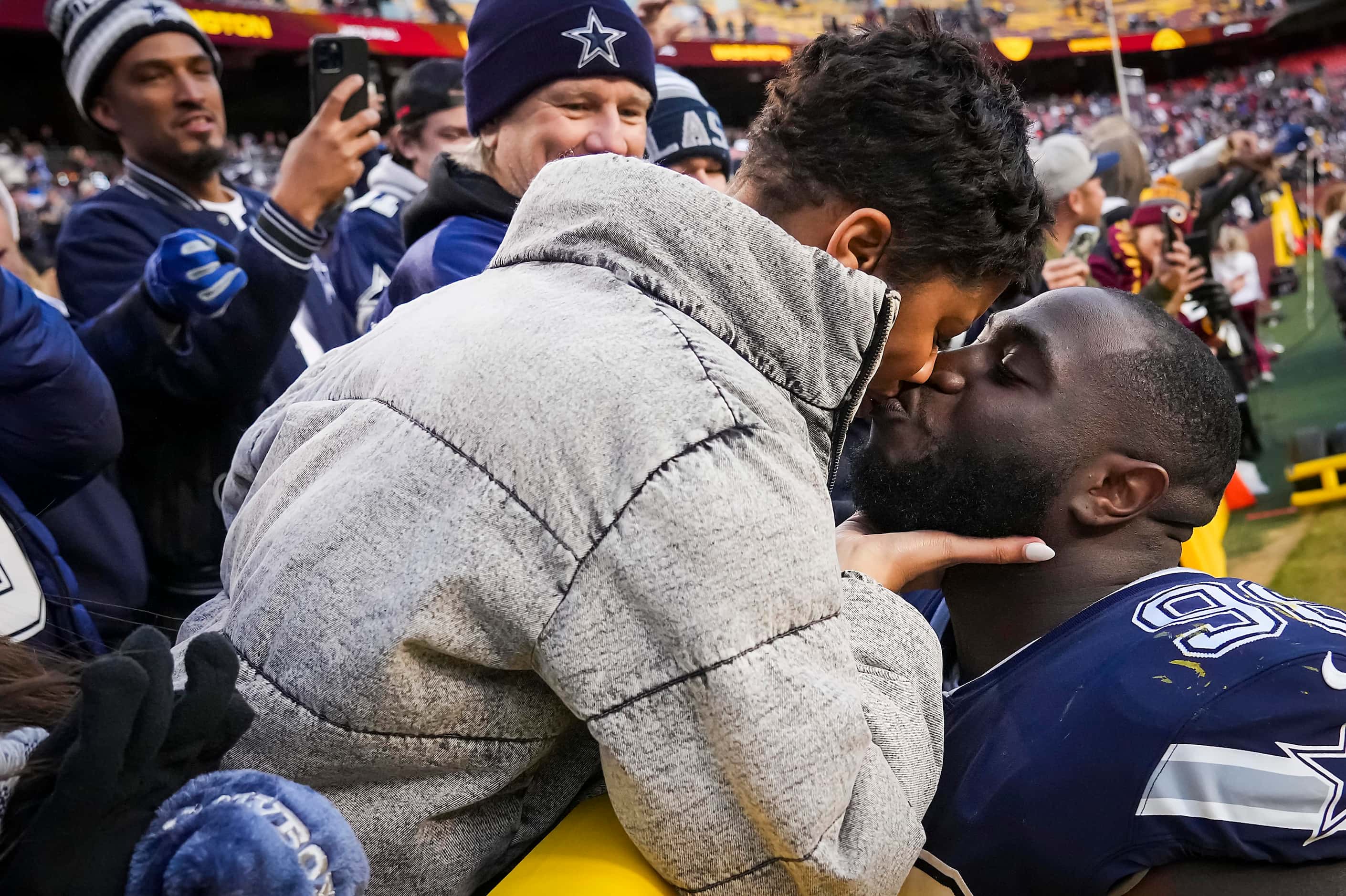 Dallas Cowboys defensive tackle Neville Gallimore gets a kiss as he leaves the field after...