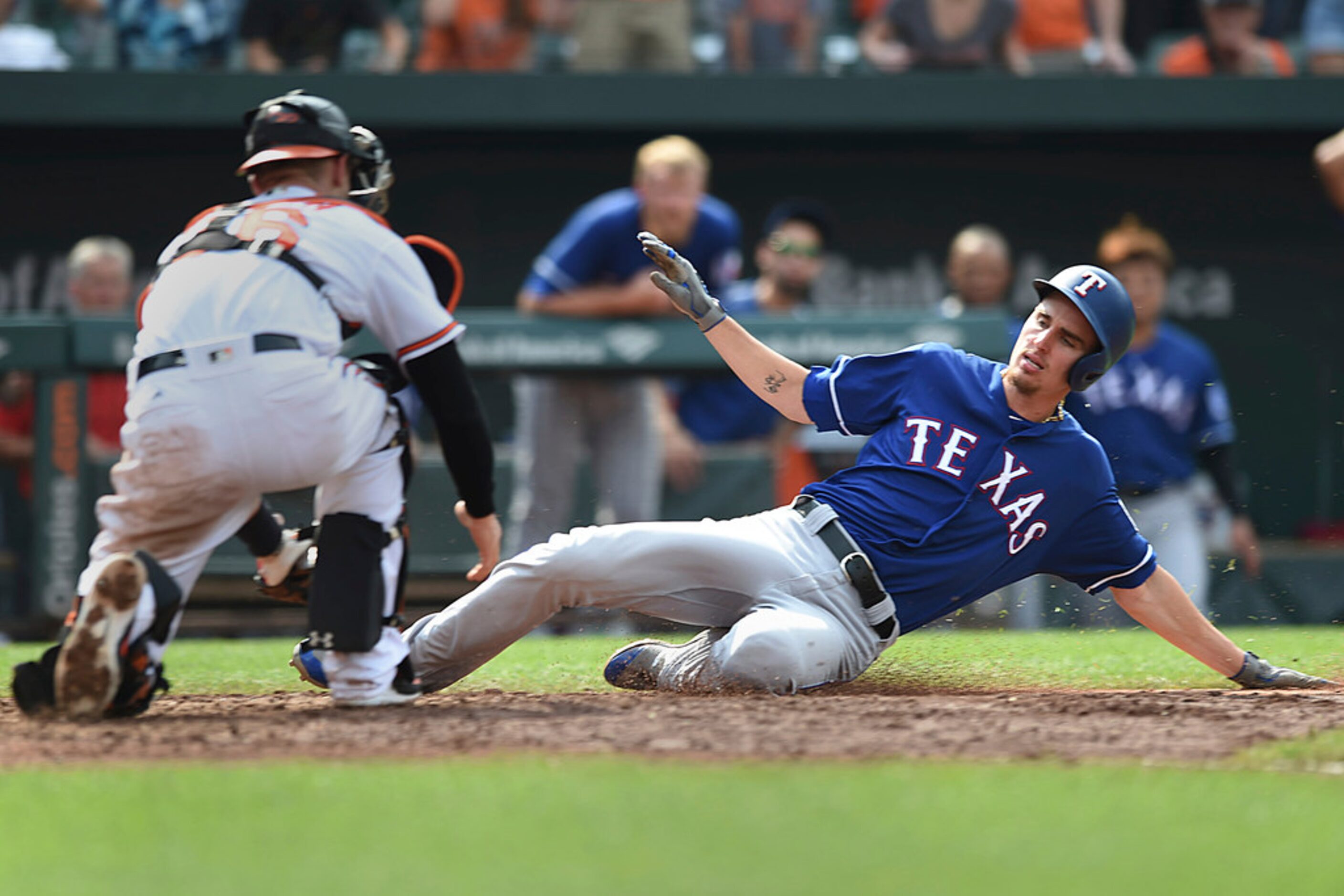 Baltimore Orioles catcher Caleb Joseph, left, waits to tag Texas Rangers' Carlos Tocci...