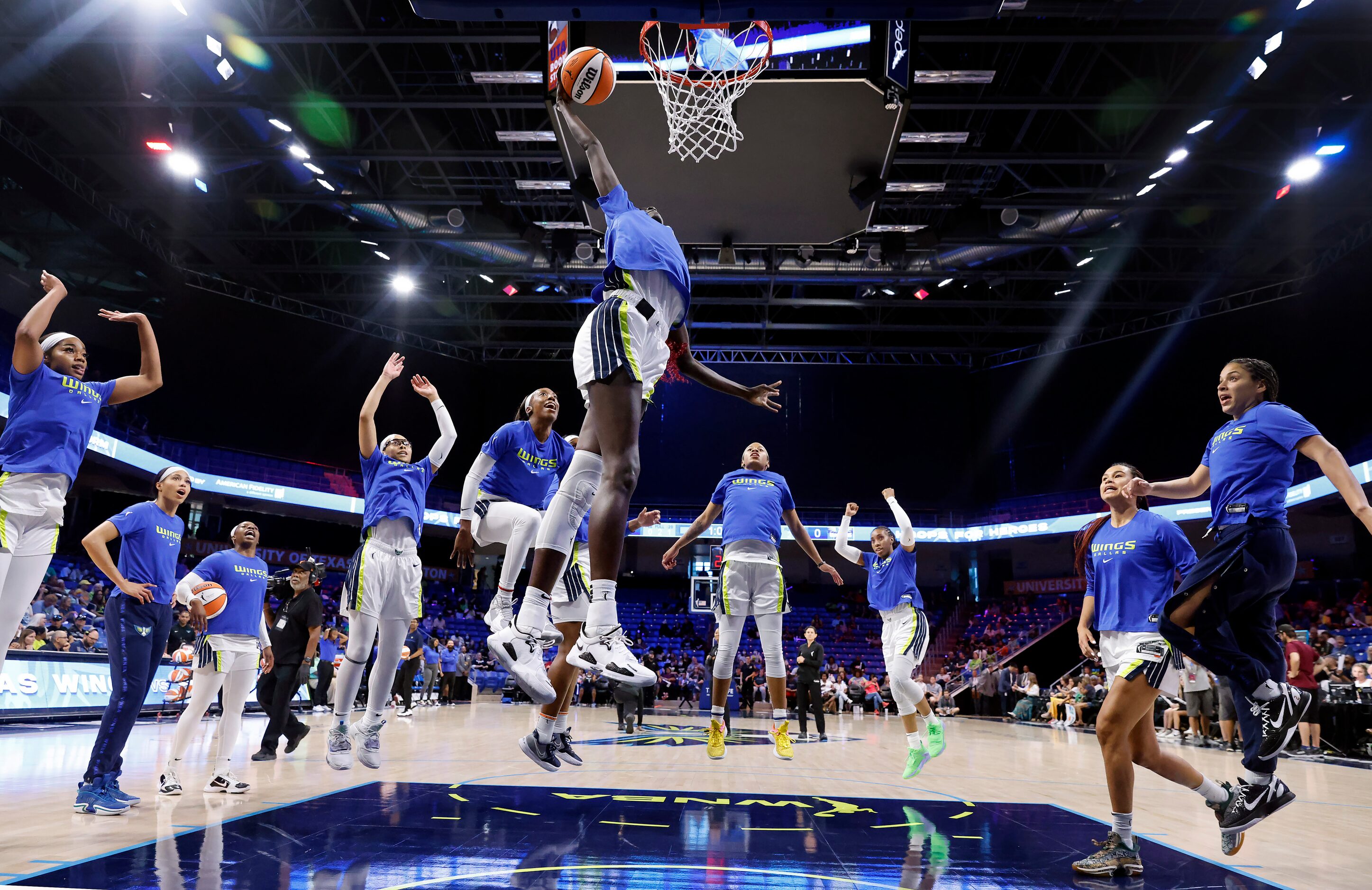 Dallas Wings center Awak Kuier (28) performs her traditional pregame dunk as her teammates...