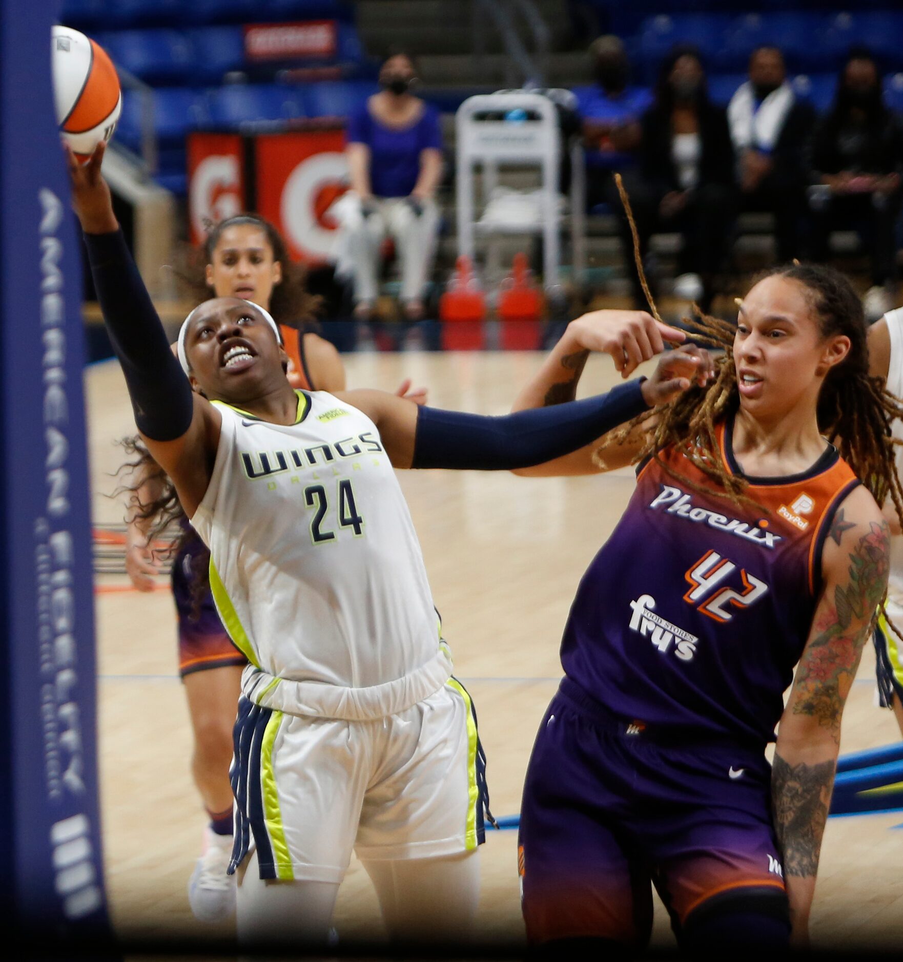 Dallas Wings guard Arike Ogunbowale (24) distances herself from the defensive pressure of...