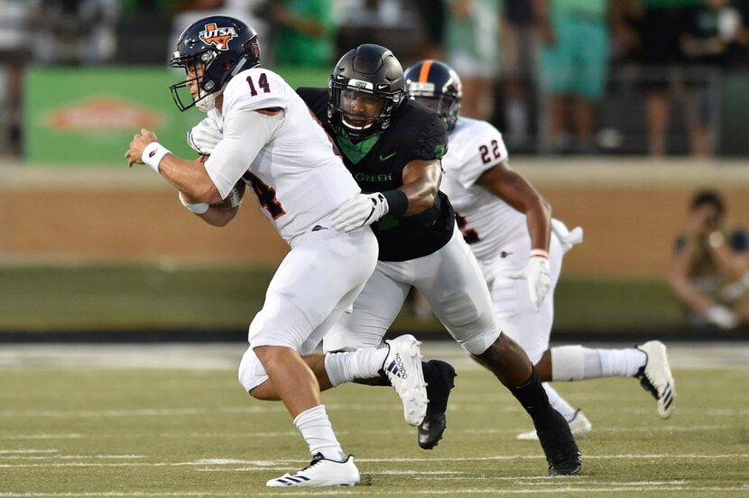 North Texas' Brandon Garner (37) sacks UTSA quarterback Dalton Sturm (14) during an NCAA...