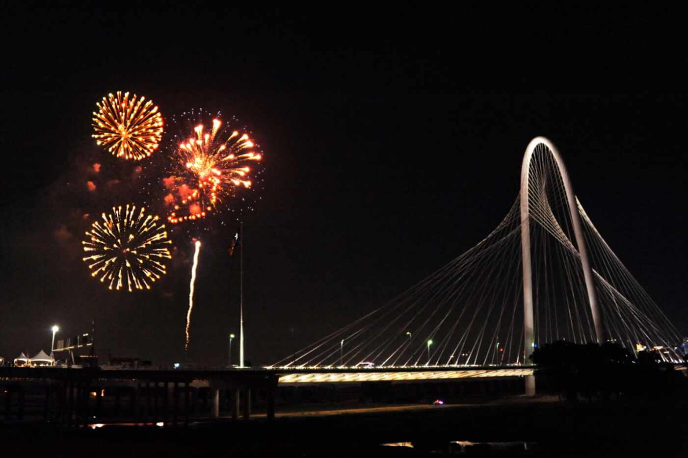 Fireworks light up the sky over the Margaret Hunt Hill Bridge at Red, White, and Boom on the...
