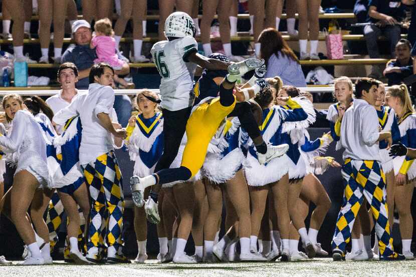 Highland Park cheerleaders react to Highland Park wide receiver Jack Toohey (11) and...