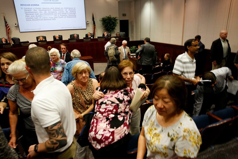 Allen resident Adelia Scaife hugs Emily Dietz just after the Allen City Council voted to...