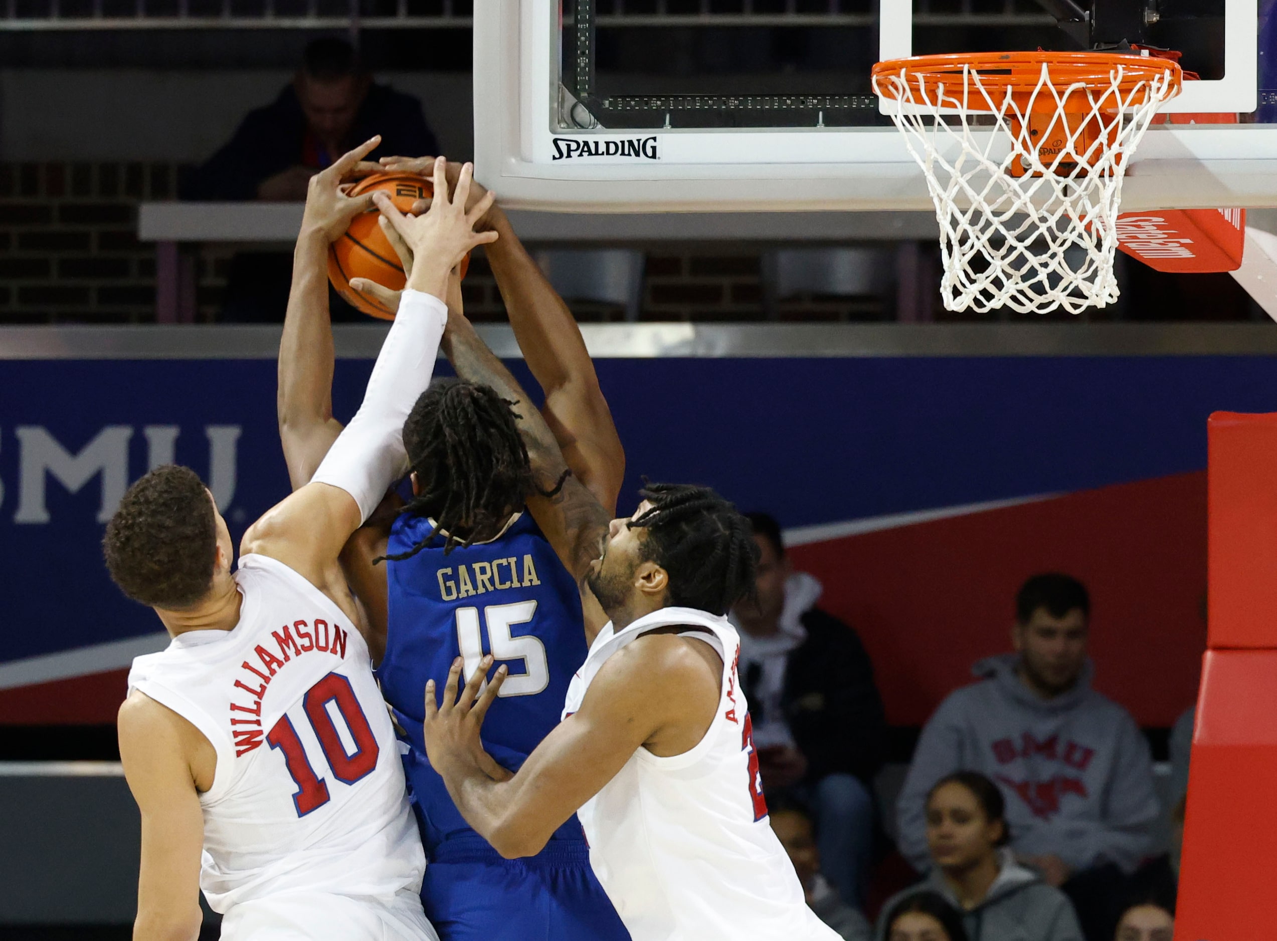 Southern Methodist forward Samuell Williamson (10), and  forward Keon Ambrose-Hylton reach...