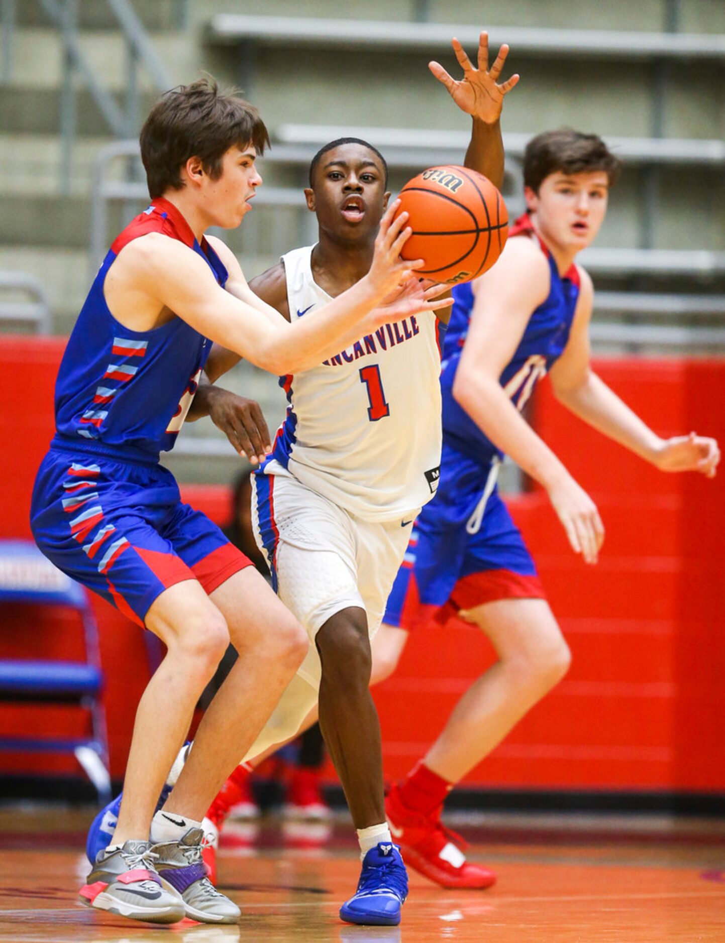 J. J. Pearce guard Bryce Johnson (3) makes a pass as he is defended by Duncanville guard...