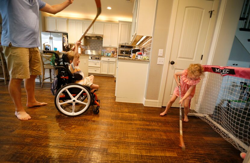 Will celebrates after he scores a goal while playing hockey with his sister, Lauren, in the...