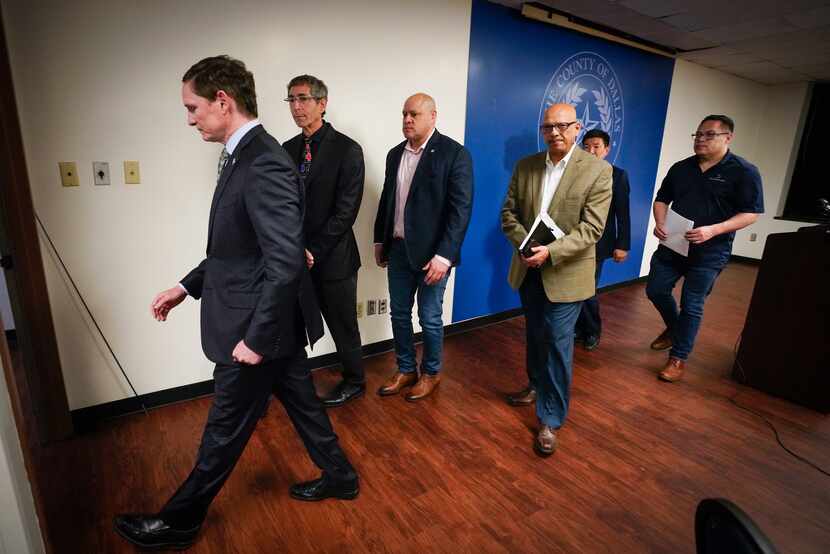 Dallas County Judge Clay Jenkins (left) departs a press conference with other city and...