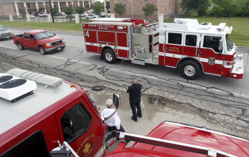 A Denton Fire/Rescue truck heads out Thursday as part of a procession from West to Waco for...