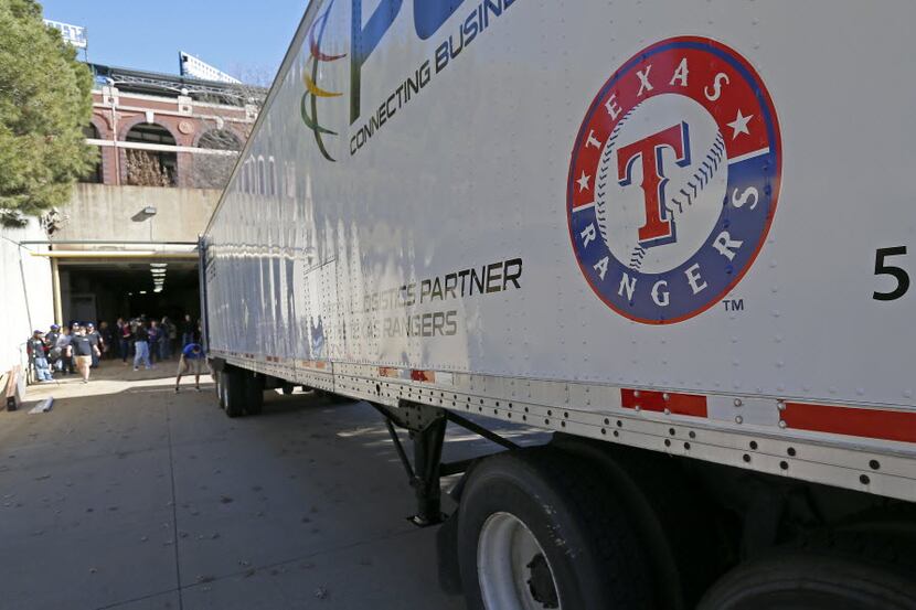 A Texas Rangers' equipment truck leaves Globe Life Park for spring training on Tuesday, Feb....