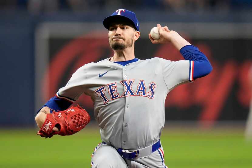 Texas Rangers starting pitcher Andrew Heaney delivers to a Tampa Bay Rays batter during the...