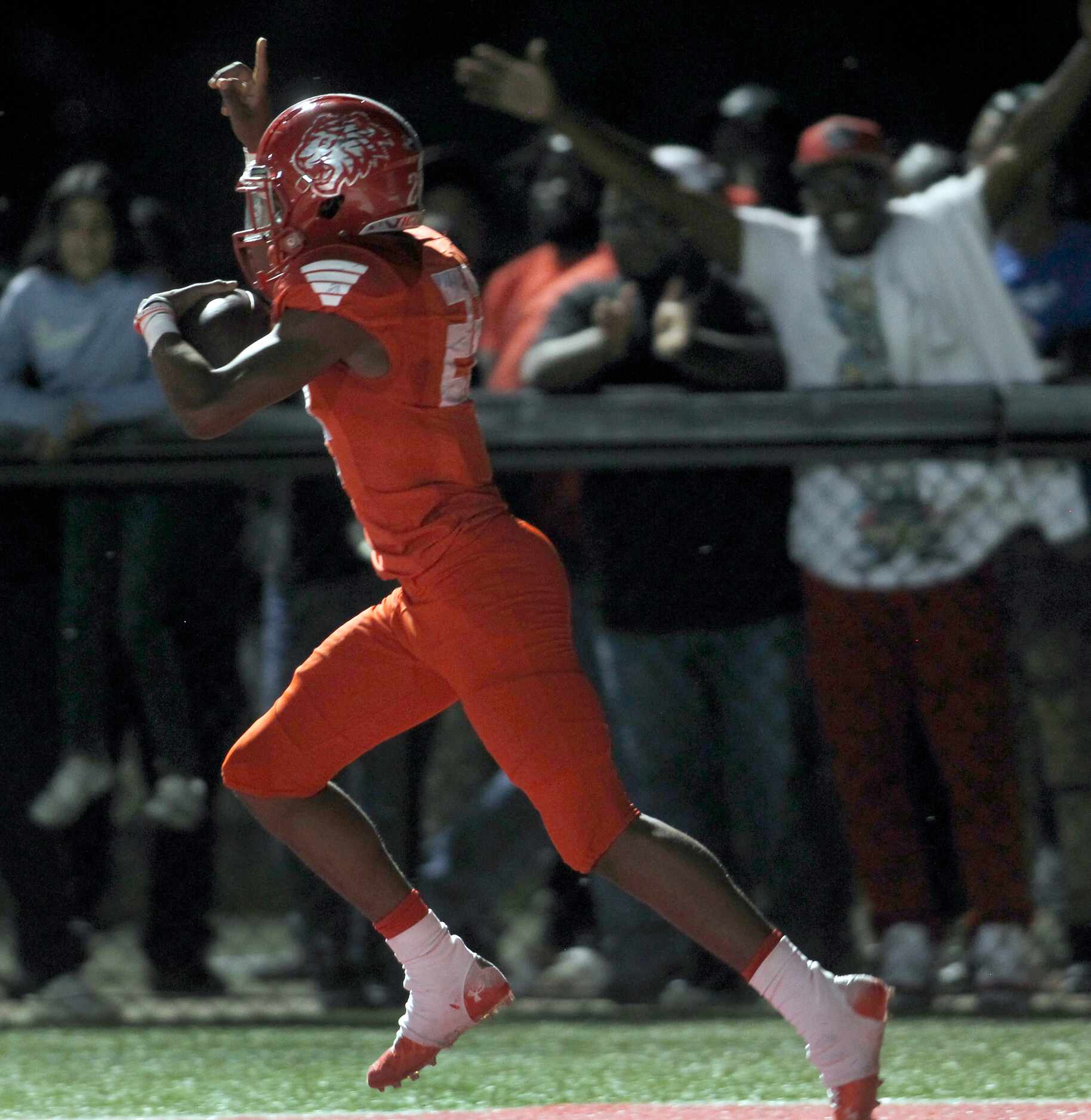 Draden Fullbright (22) gestures as he races to the team bench area after scoring a rushing...