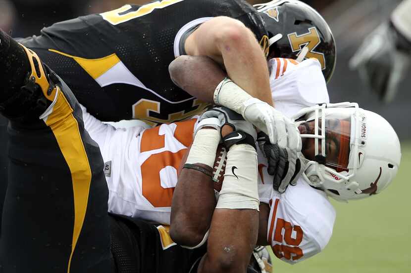 D.J. Monroe (26) of the Texas Longhorns is tackled by the Missouri Tigers defense during the...