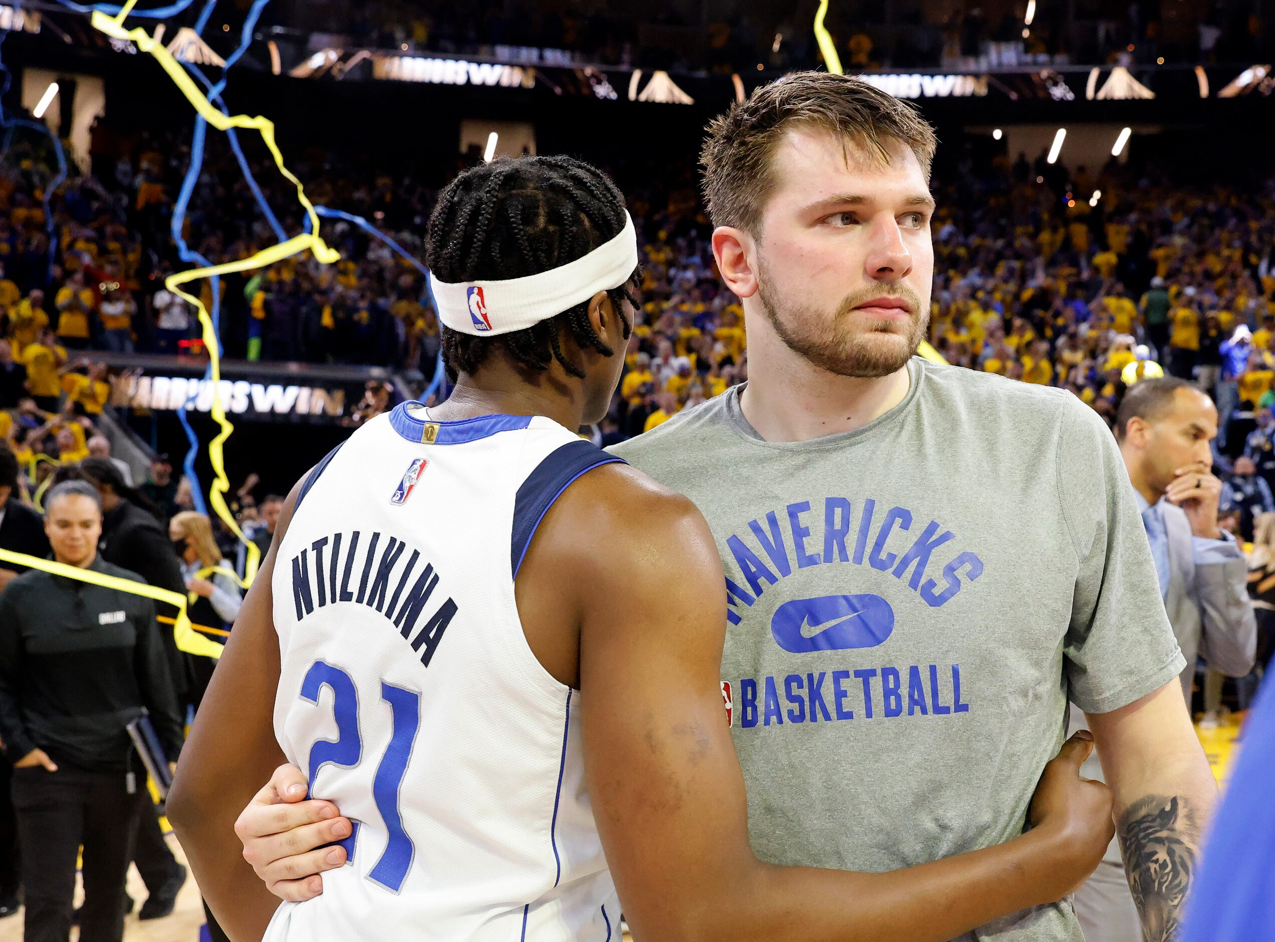 Dallas Mavericks guards Luka Doncic (77) and Frank Ntilikina (21) hug following their Game 5...