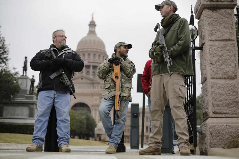  Gun rights advocates carry rifles while protesting outside the Texas Capitol on Jan. 13,...