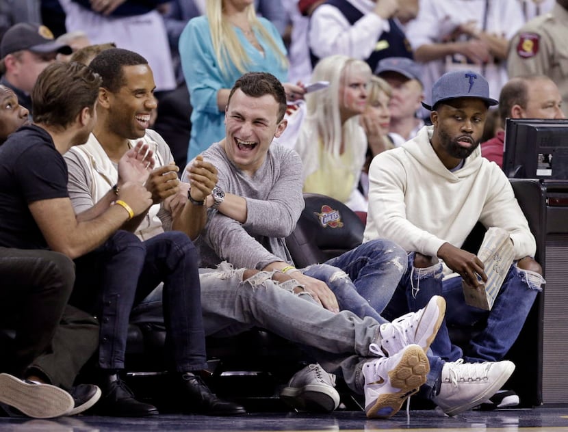 Cleveland Browns quarterback Johnny Manziel, third from left, laughs with friends at the end...