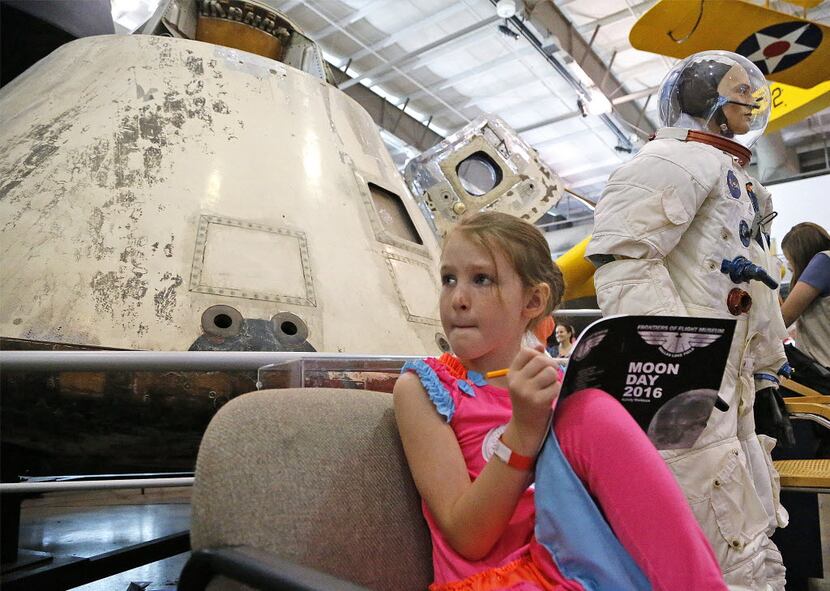 Macy Cleveland, then 7, of Royce City, filled out a Moon Day work book in front of the...