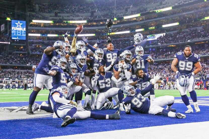 Dallas Cowboys defensive unit celebrate after recovering a fumble during the fist half of an...
