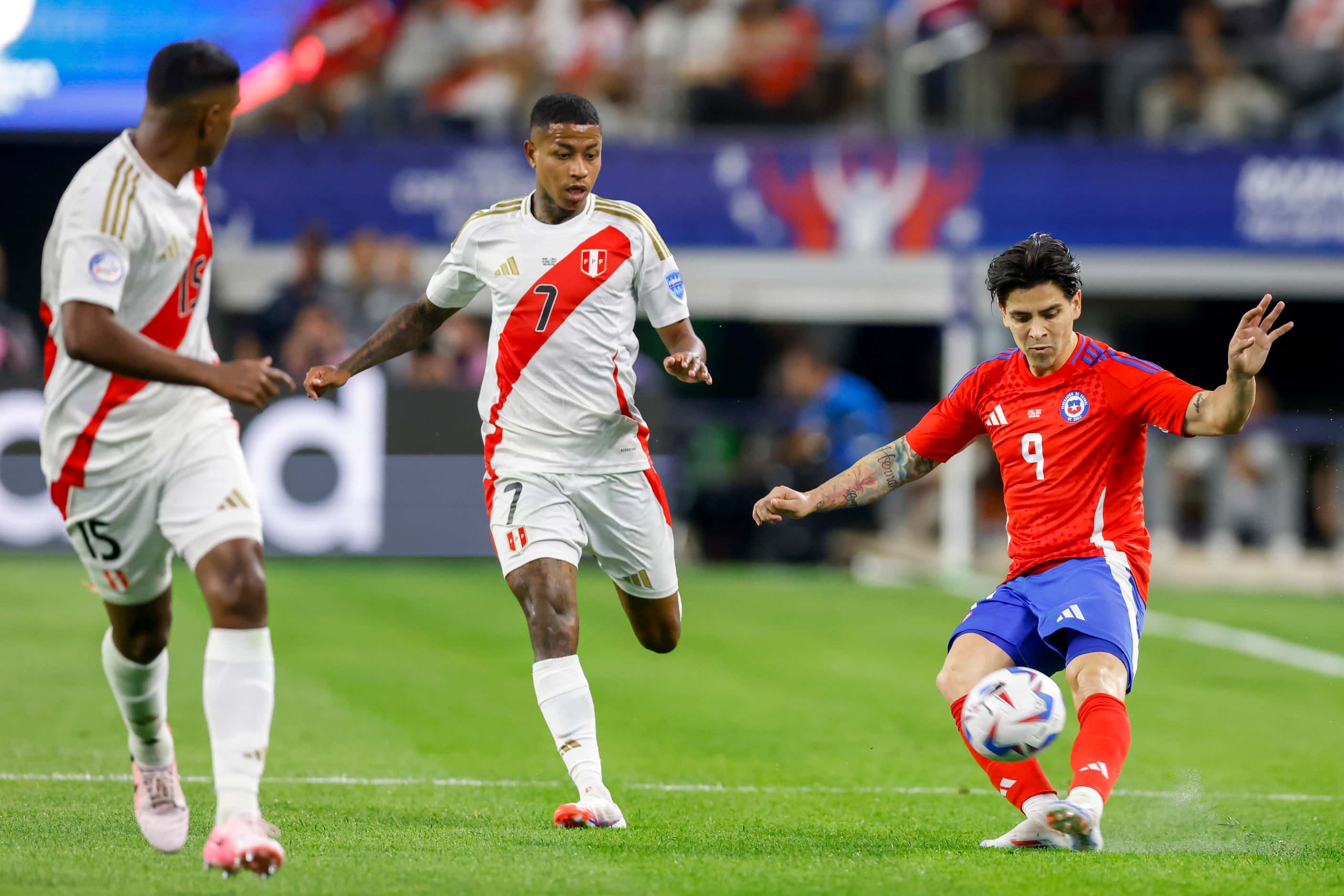 Chile forward Víctor Dávila (9) crosses the ball ahead of Peru forward Andy Polo (7) and...