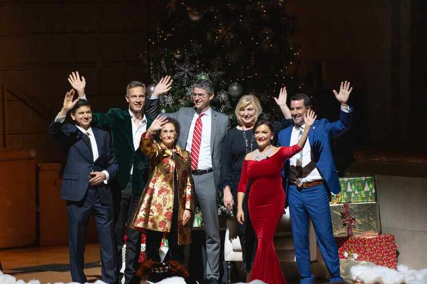 Dallas Symphony Orchestra C-Suite Christmas performers stand on stage and wave.