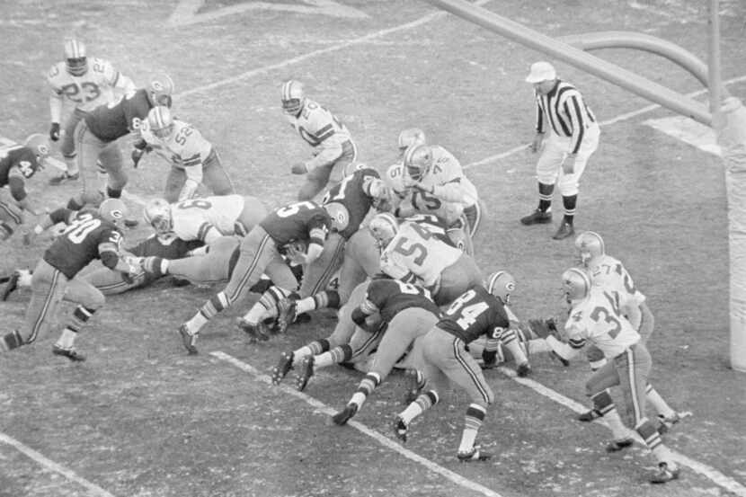 In this Dec. 31, 1967, file photo, Green Bay Packers quarterback Bart Starr (15), follows...