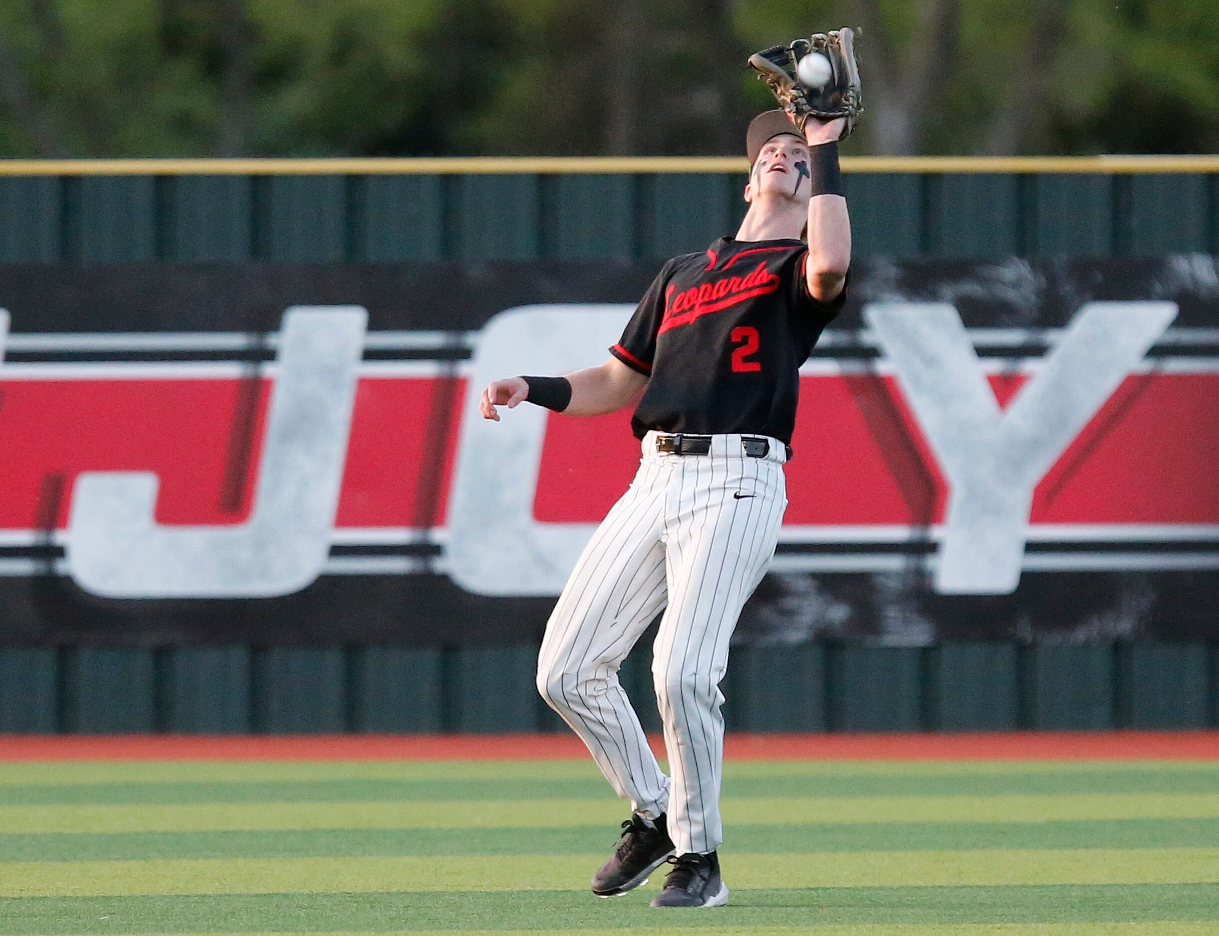 Lovejoy High School left fielder Trent Rucker (2) catches a pop fly in the first inning as...