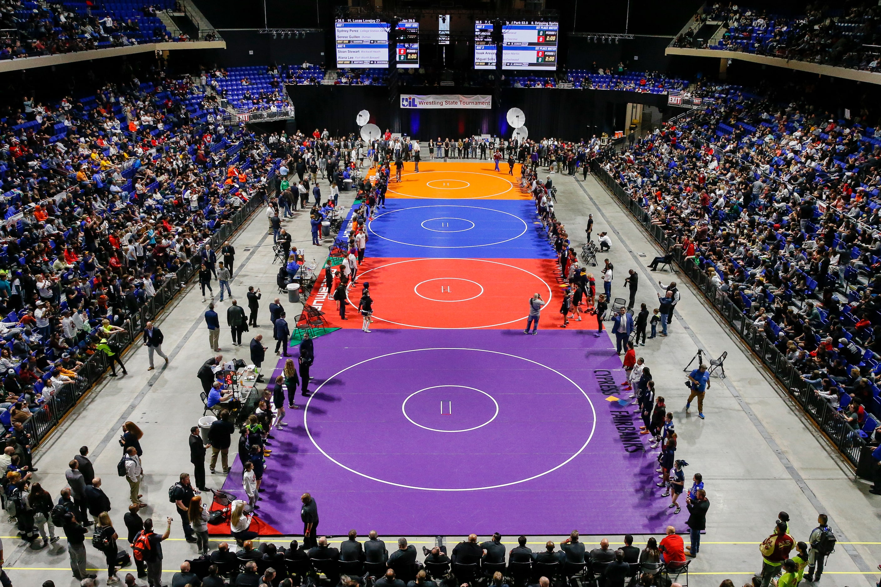 Wrestlers enter the arena floor during the parade of champions at the UIL State Wrestling...