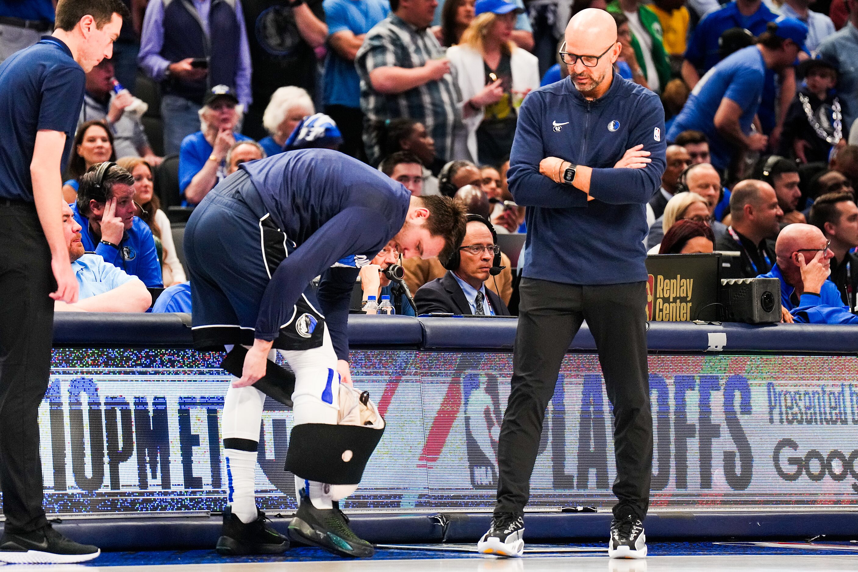 Dallas Mavericks head coach Jason Kidd looks on as guard Luka Doncic removes a wrap on this...