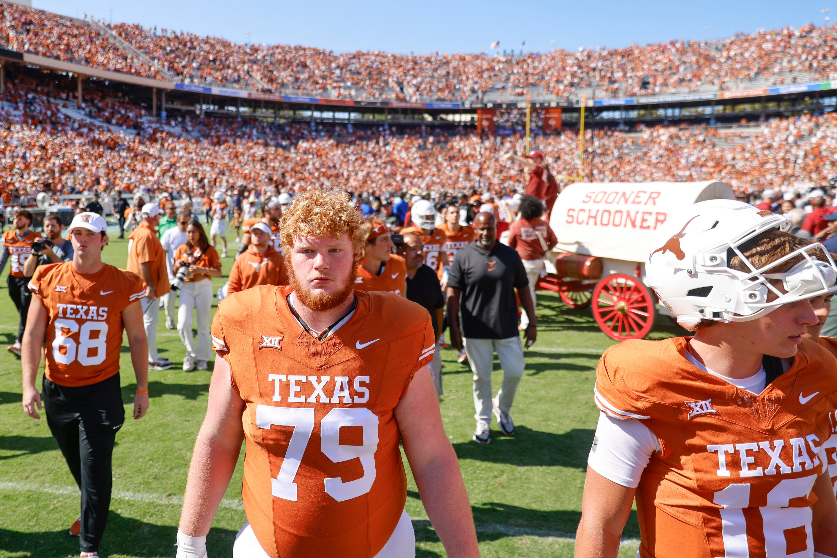 Texas players including Texas offensive lineman Connor Stroh (79) leave the field after...