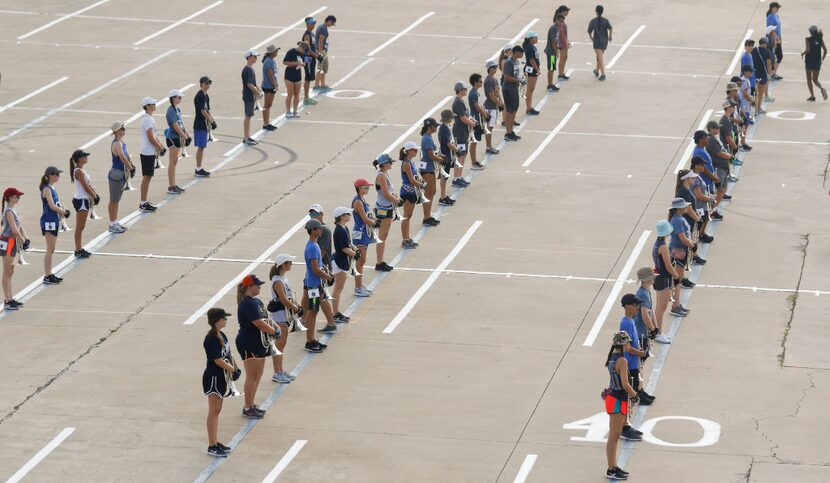 Members of the Keller High School Indian Band line up during practice Wednesday morning...