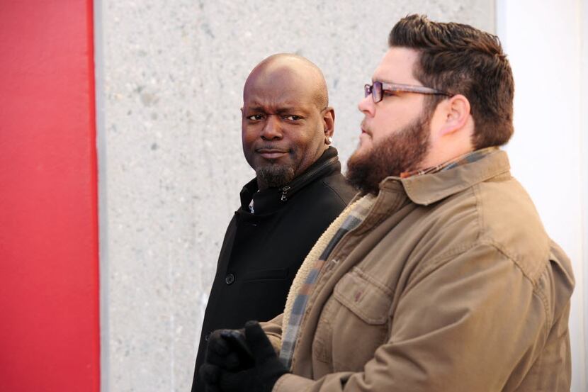 In this photo provided by CBS, former NFL player Emmitt Smith, left, looks towards actor...