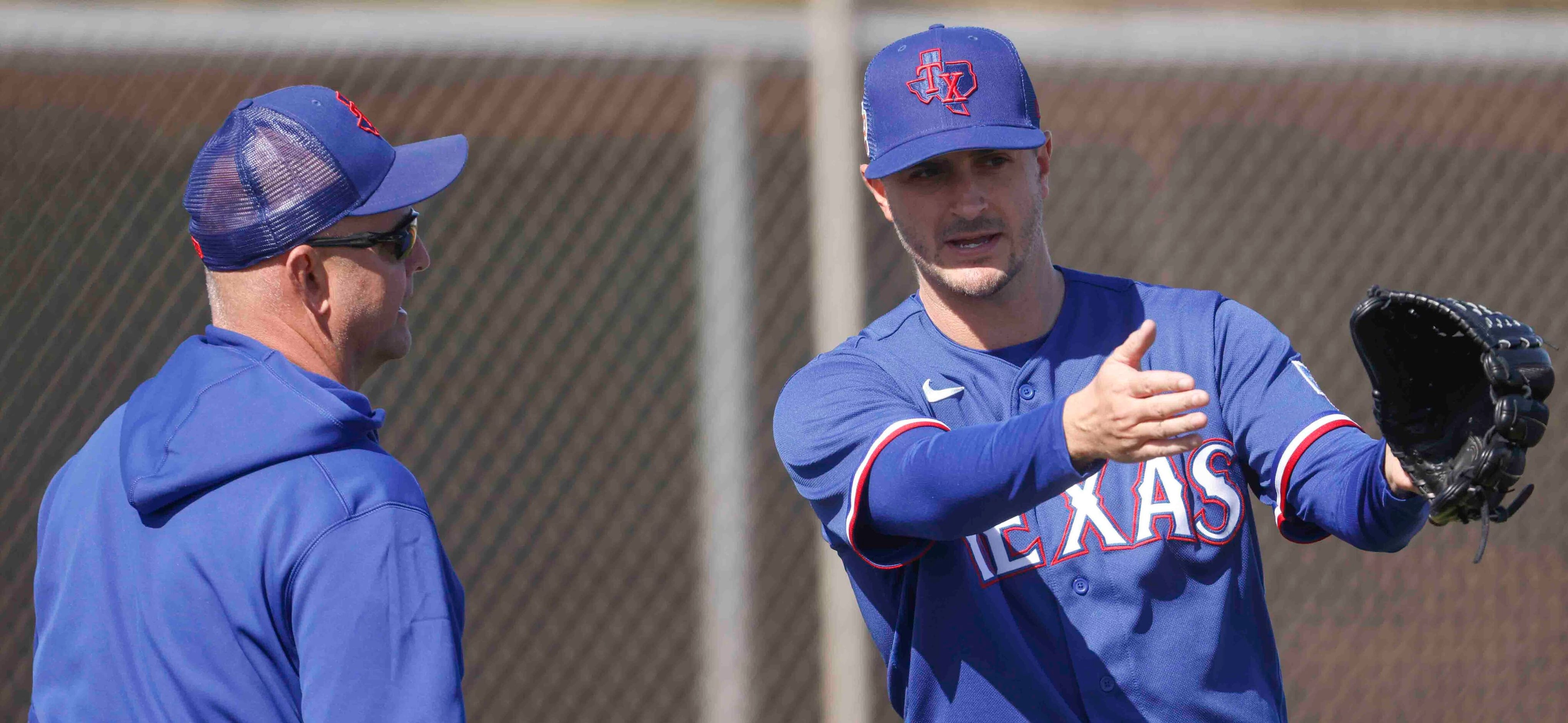 Texas Rangers minor league pitching coordinator Danny Clark, left, interacts with Texas...