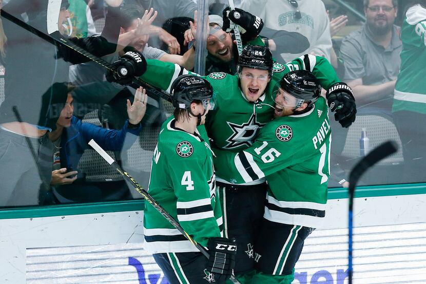 Dallas Stars forward Roope Hintz, center, is congratulated by defenseman Miro Heiskanen (4)...