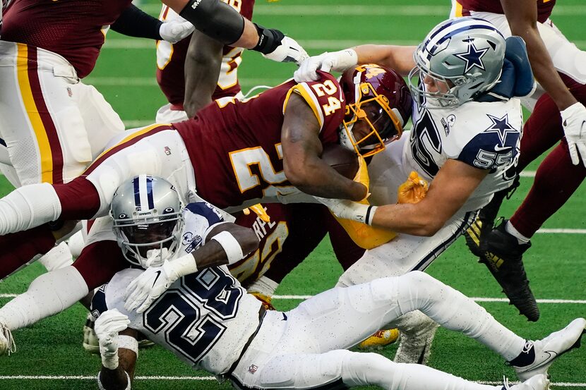 Washington Football Team running back Antonio Gibson (24) is brought down by Dallas Cowboys...