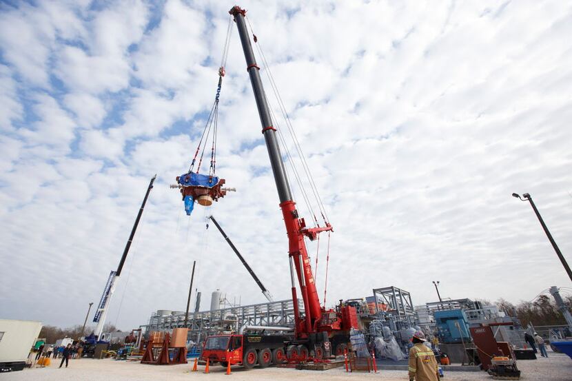 A crane hauls a 70-ton turbine in La Porte, Texas, Dec. 20, 2016. A consortium of companies...