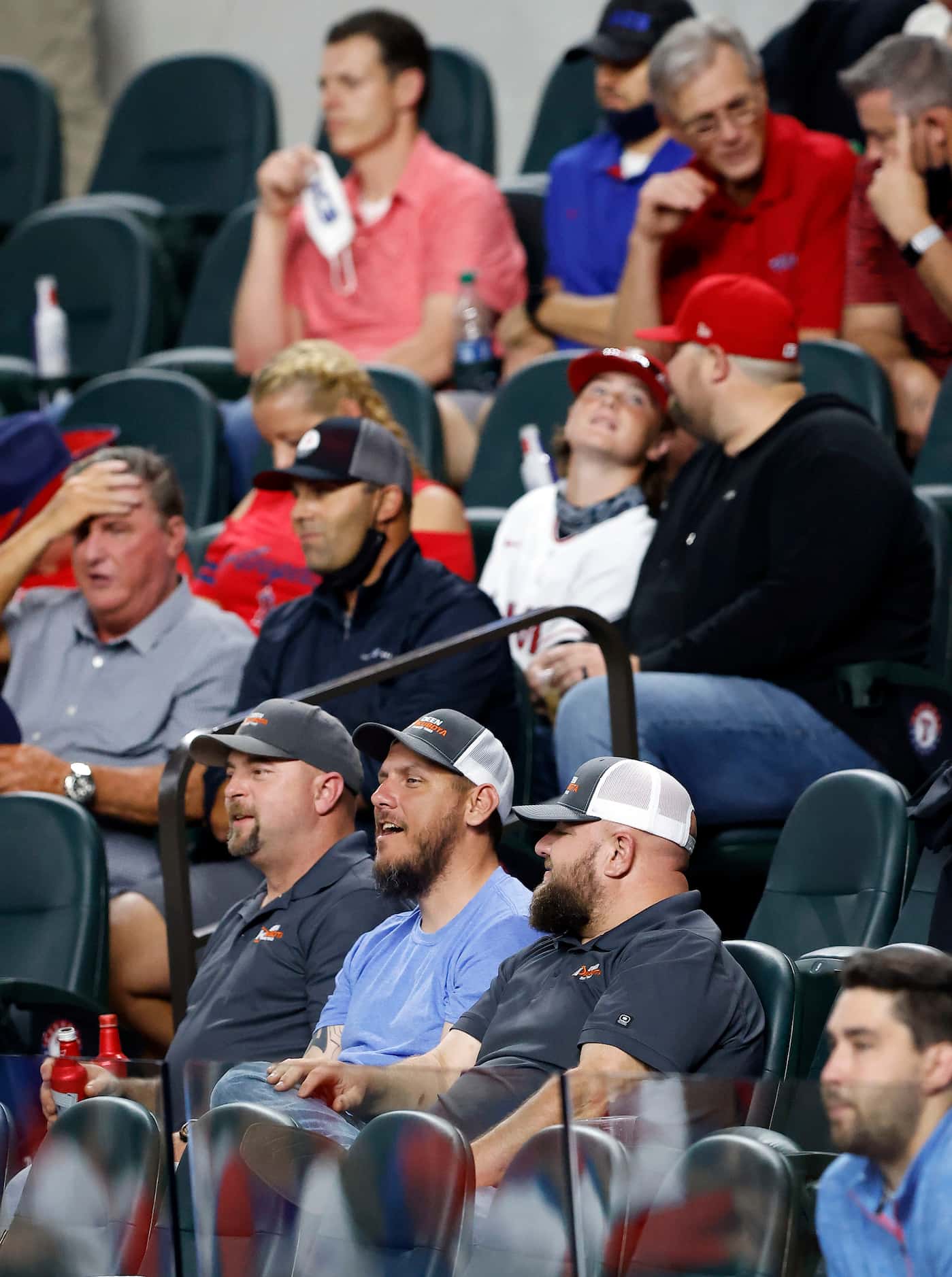 Texas Rangers fans not wearing masks watch their team face the Los Angeles Angels during the...