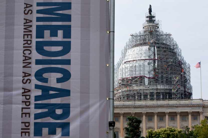 In this July 30, 2015 file photo, a sign supporting Medicare is seen on Capitol Hill in...