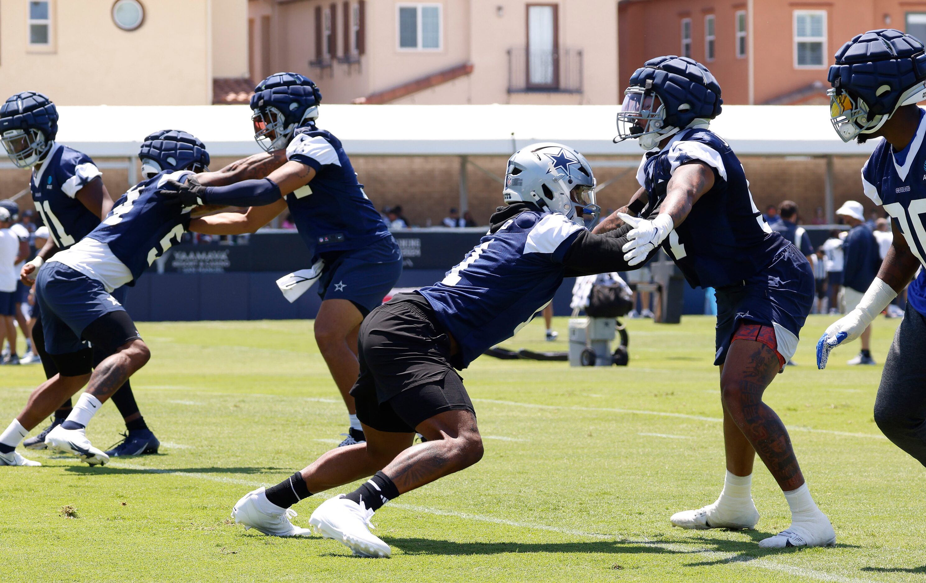 Dallas Cowboys linebacker Micah Parsons (11, center) runs a pass rushing drill during a...