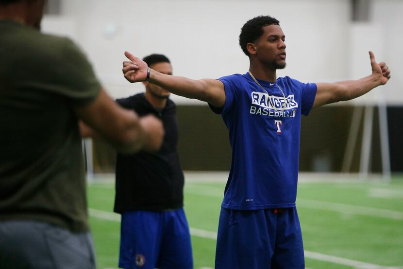 Texas Rangers minor league player Leody Taveras stretches during training at Arlington High...