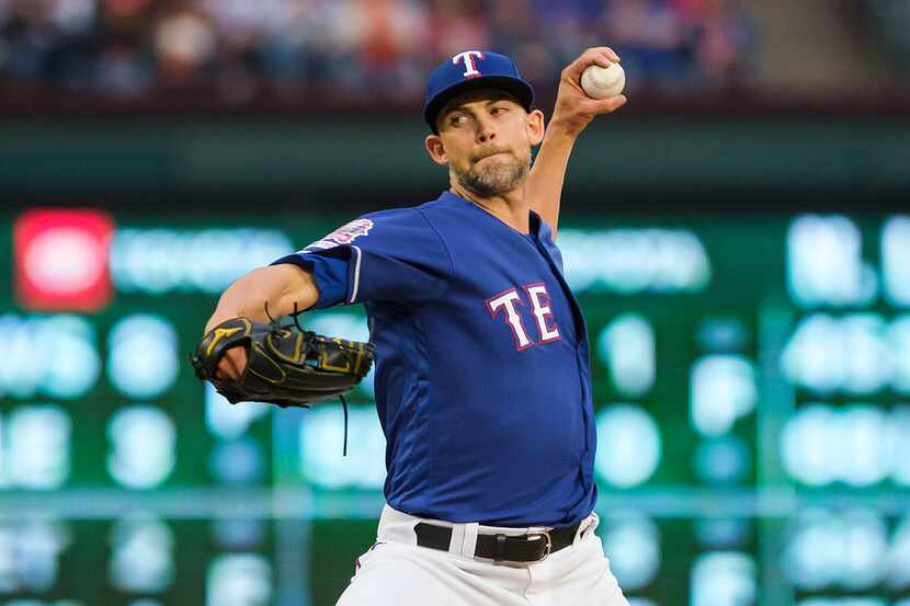 Texas Rangers pitcher Mike Minor throws during the first inning against the Houston Astros...