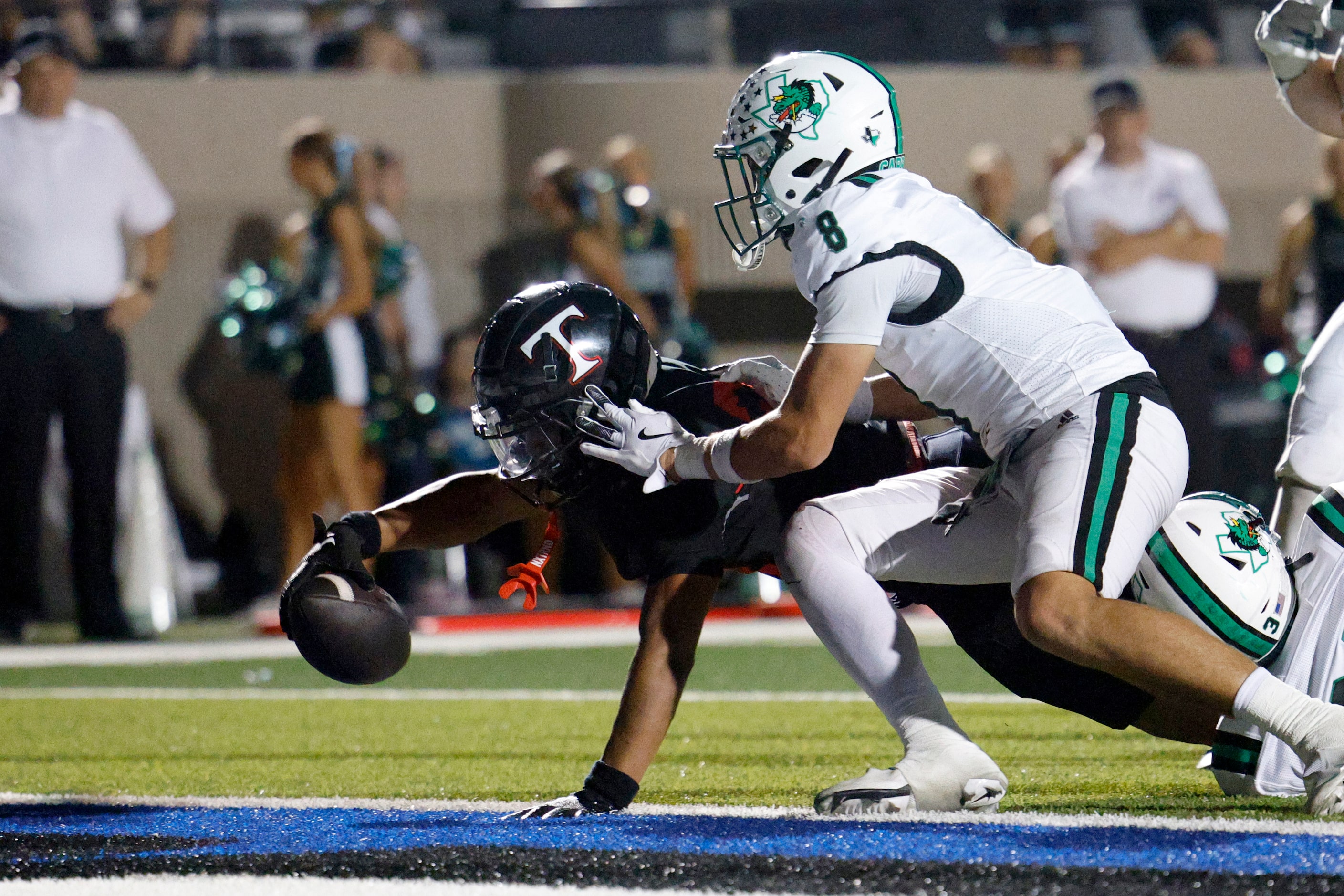 Euless Trinity running back JT Harris (24) stretches the ball across the goal line for a...