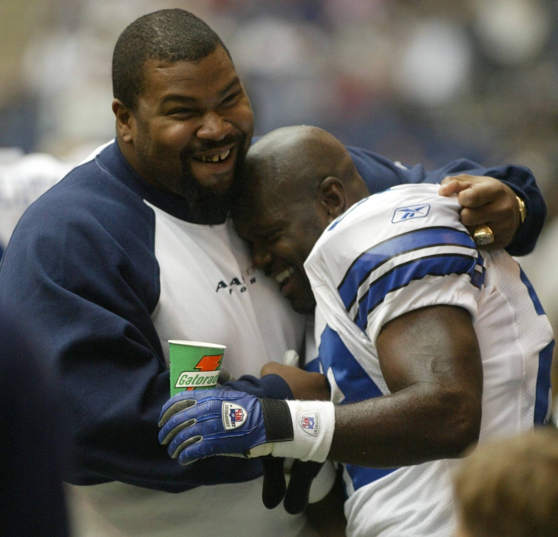 Dallas Cowboys offensive lineman Larry Allen, left, hugs running back Emmitt Smith after he...