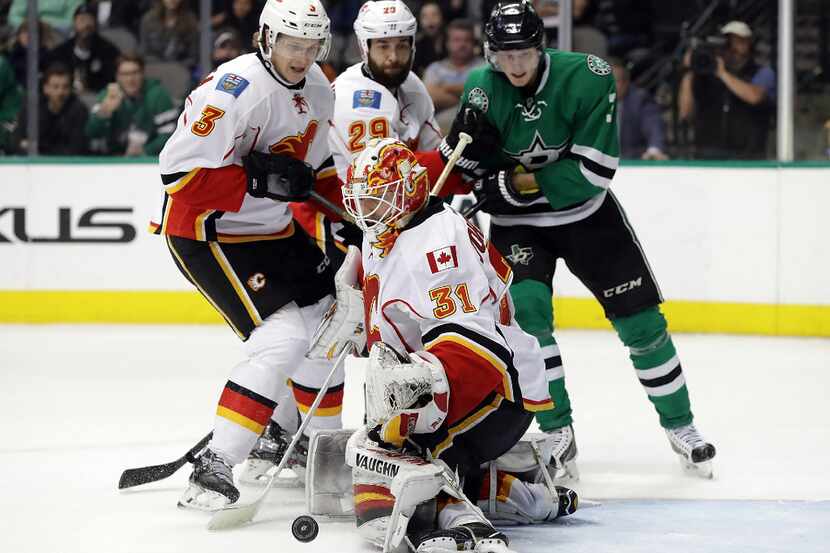 DALLAS, TX - DECEMBER 06:  Chad Johnson #31 of the Calgary Flames makes a save against the...