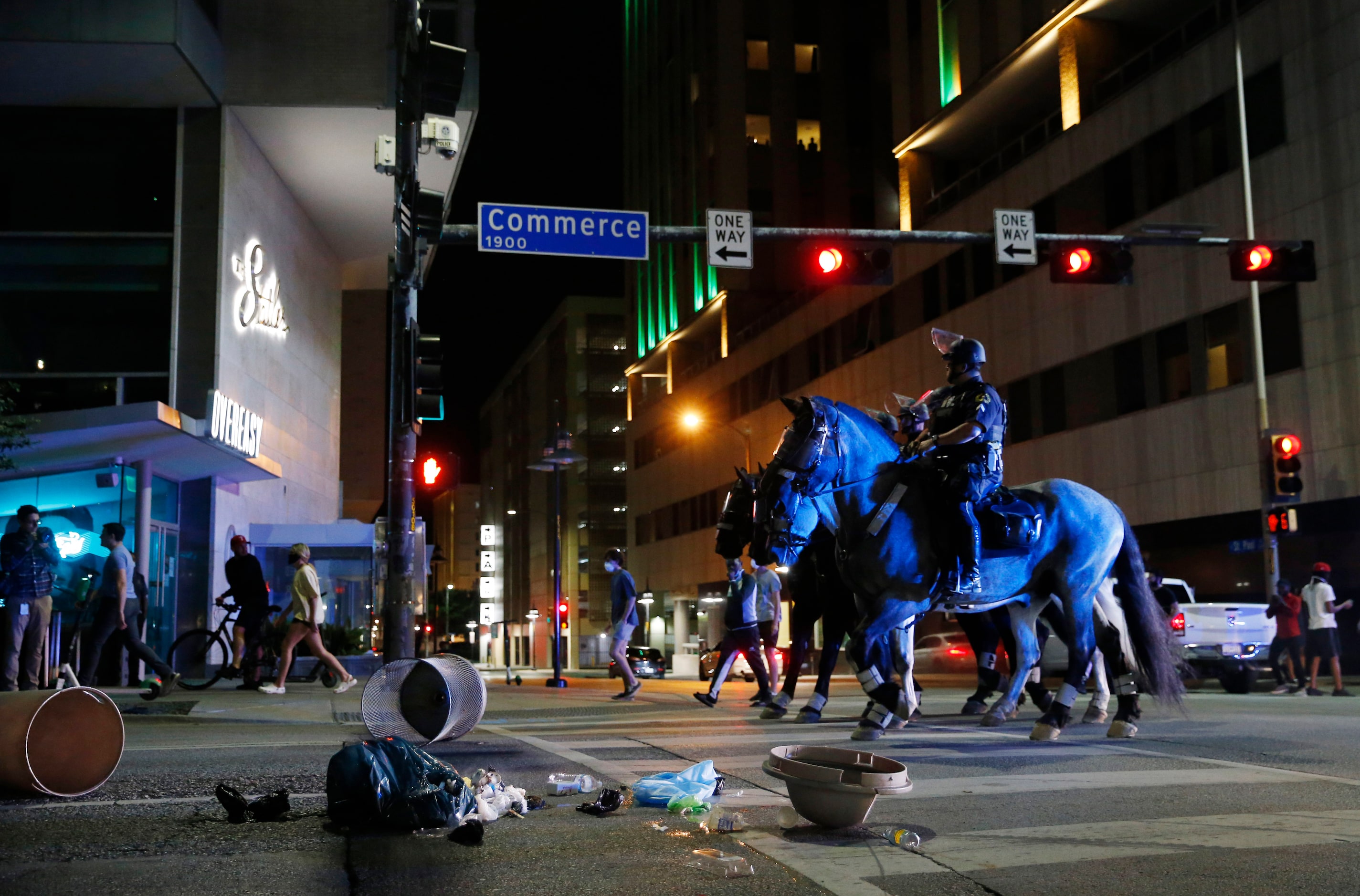 Dallas police make their way along Commerce amongst debris put in the street by protestors...