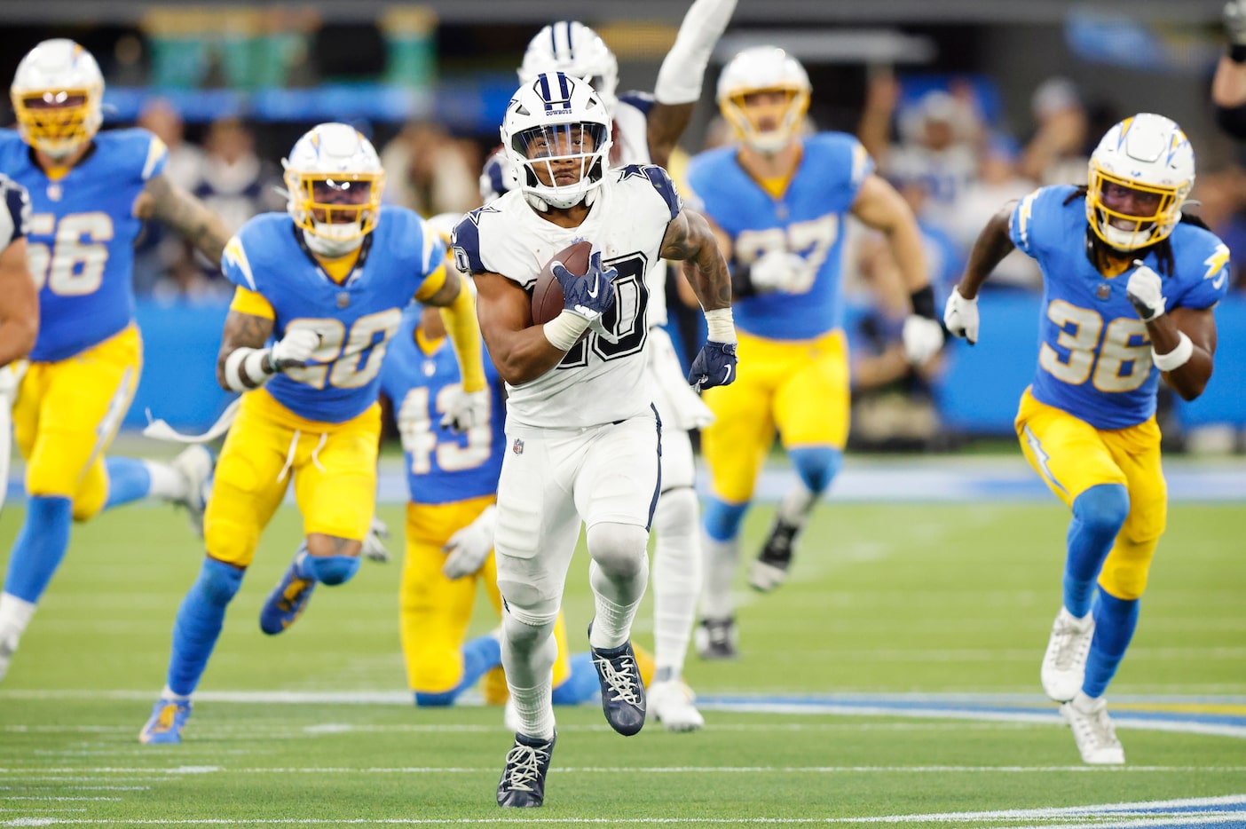 Dallas Cowboys running back Tony Pollard (20) breaks away down the middle of the field for a...