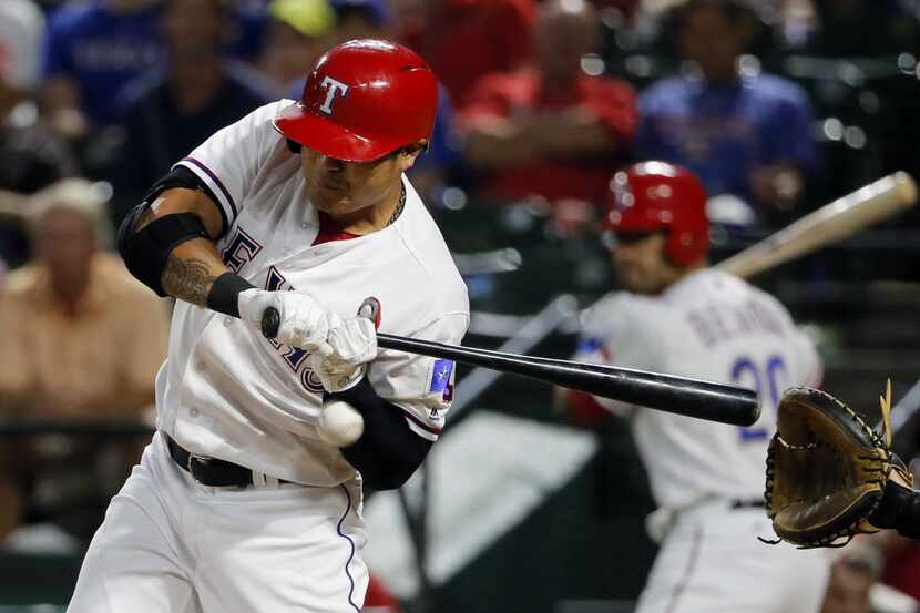 Texas Rangers' Shin-Soo Choo, of South Korea, is hit in the left wrist by a pitch from...