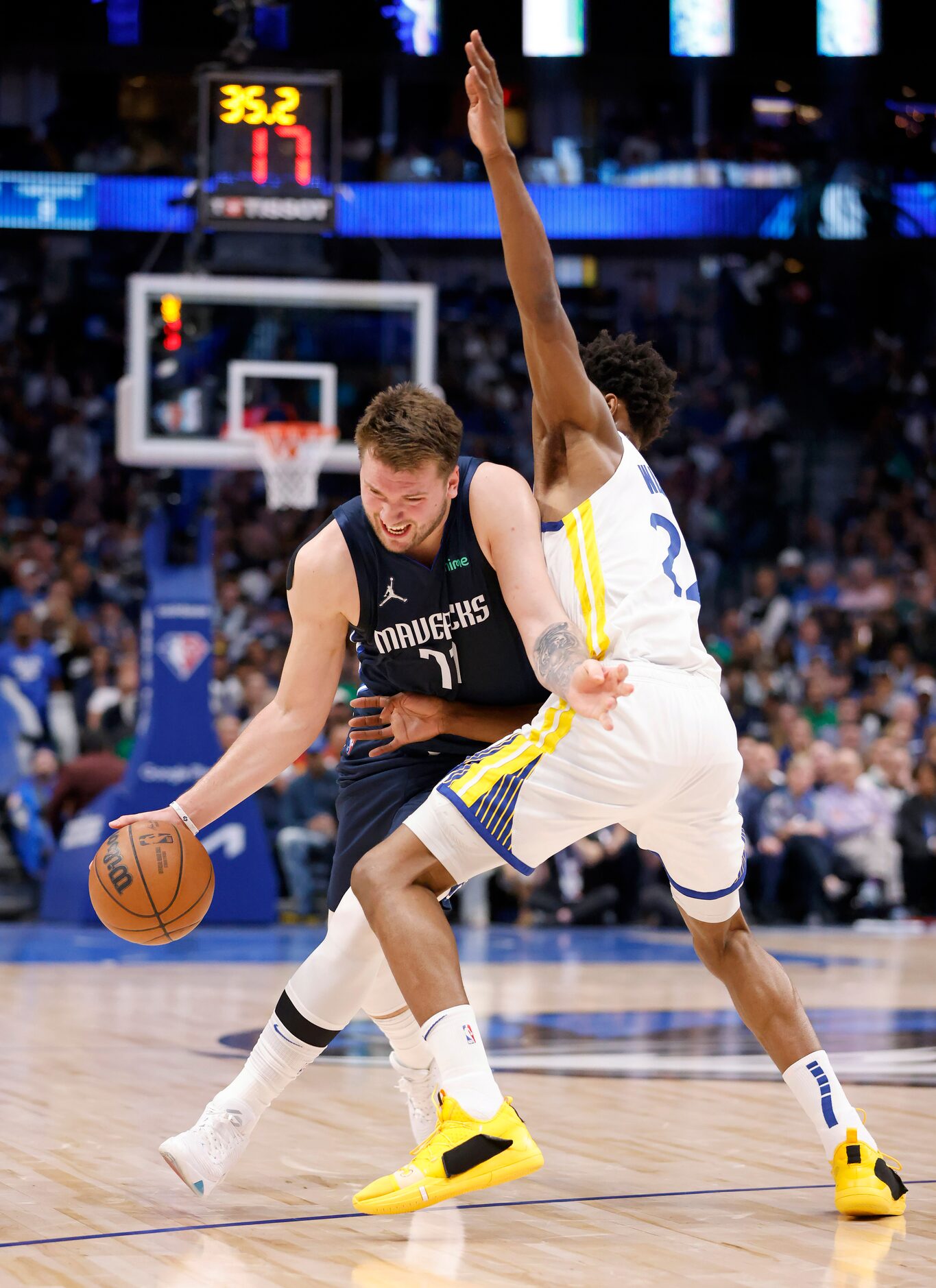 Dallas Mavericks guard Luka Doncic (77) tries to get around Golden State Warriors forward...