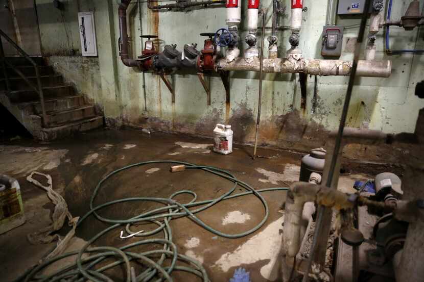 Water leaks onto the floor of the boiler room at Thomas A. Edison Middle Learning Center in...