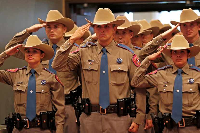Members of the 155th trooper training class salute during the ceremony.