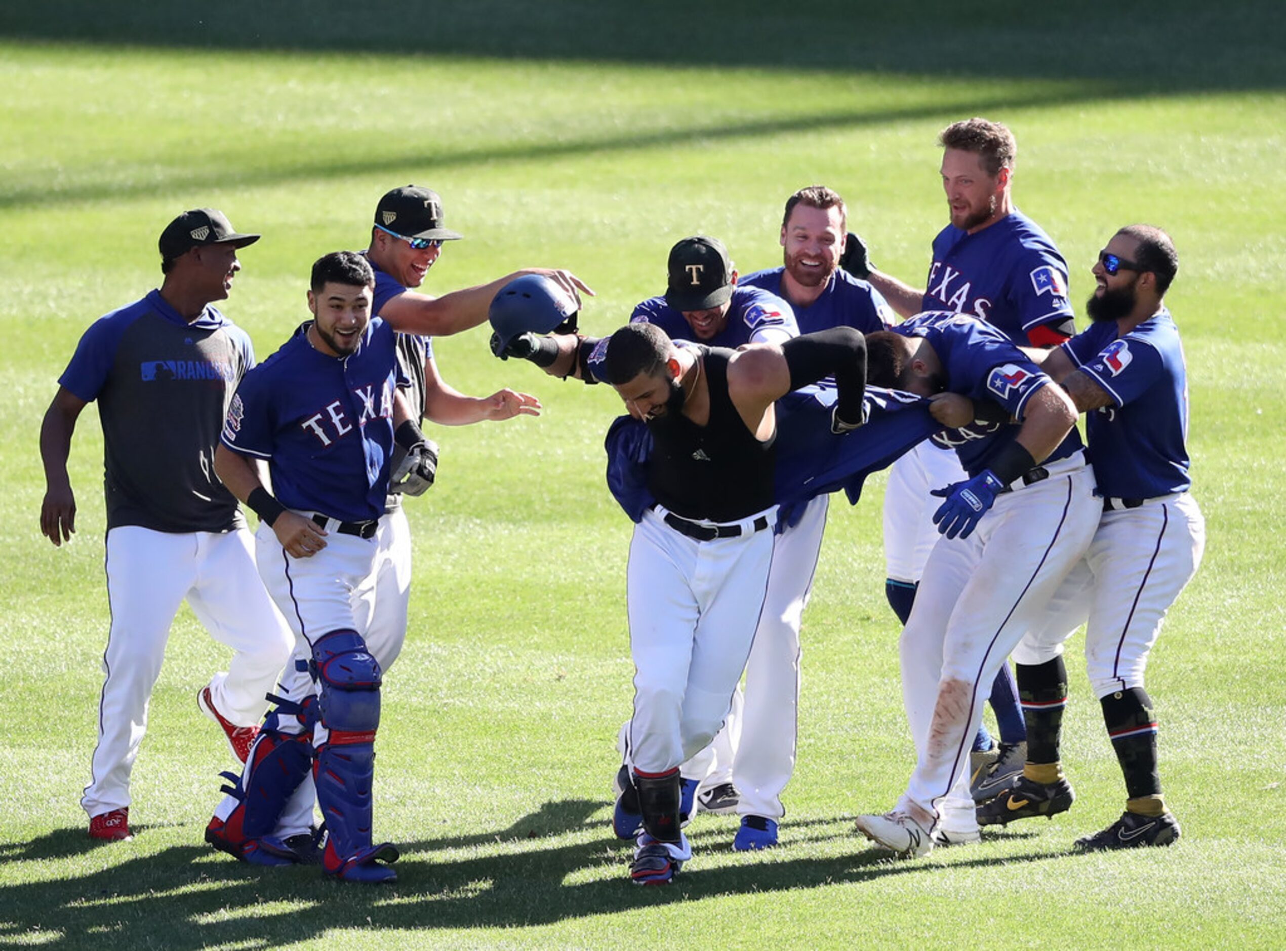 ARLINGTON, TEXAS - MAY 19:  The Texas Rangers celebrate the game winning run scored on a...